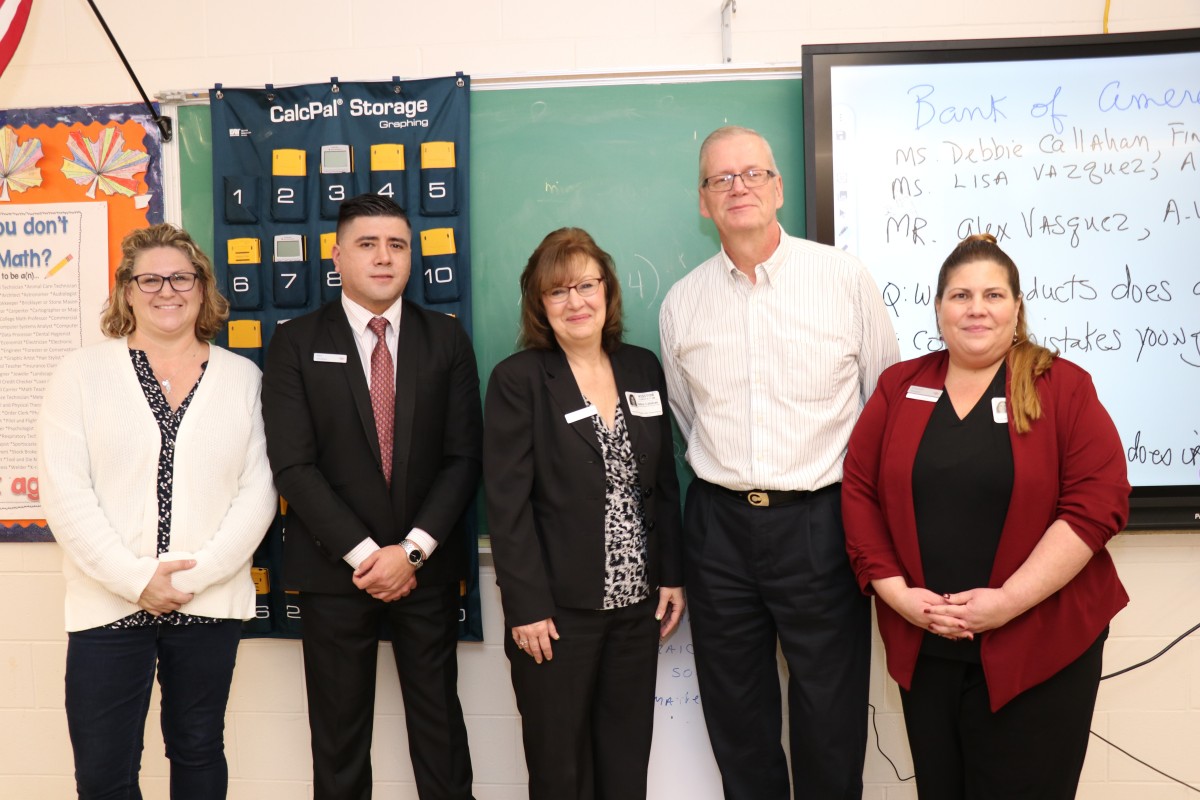 Representatives and teachers pose for a photo.