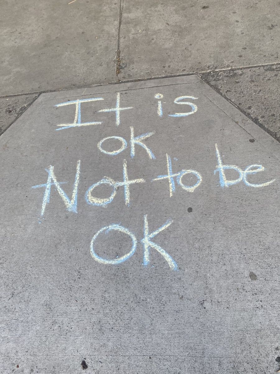 Sidewalk chalk with positive messages about mental health.