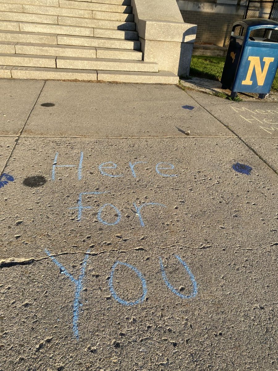 Sidewalk chalk with positive messages about mental health.