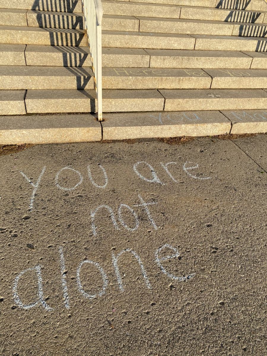 Sidewalk chalk with positive messages about mental health.