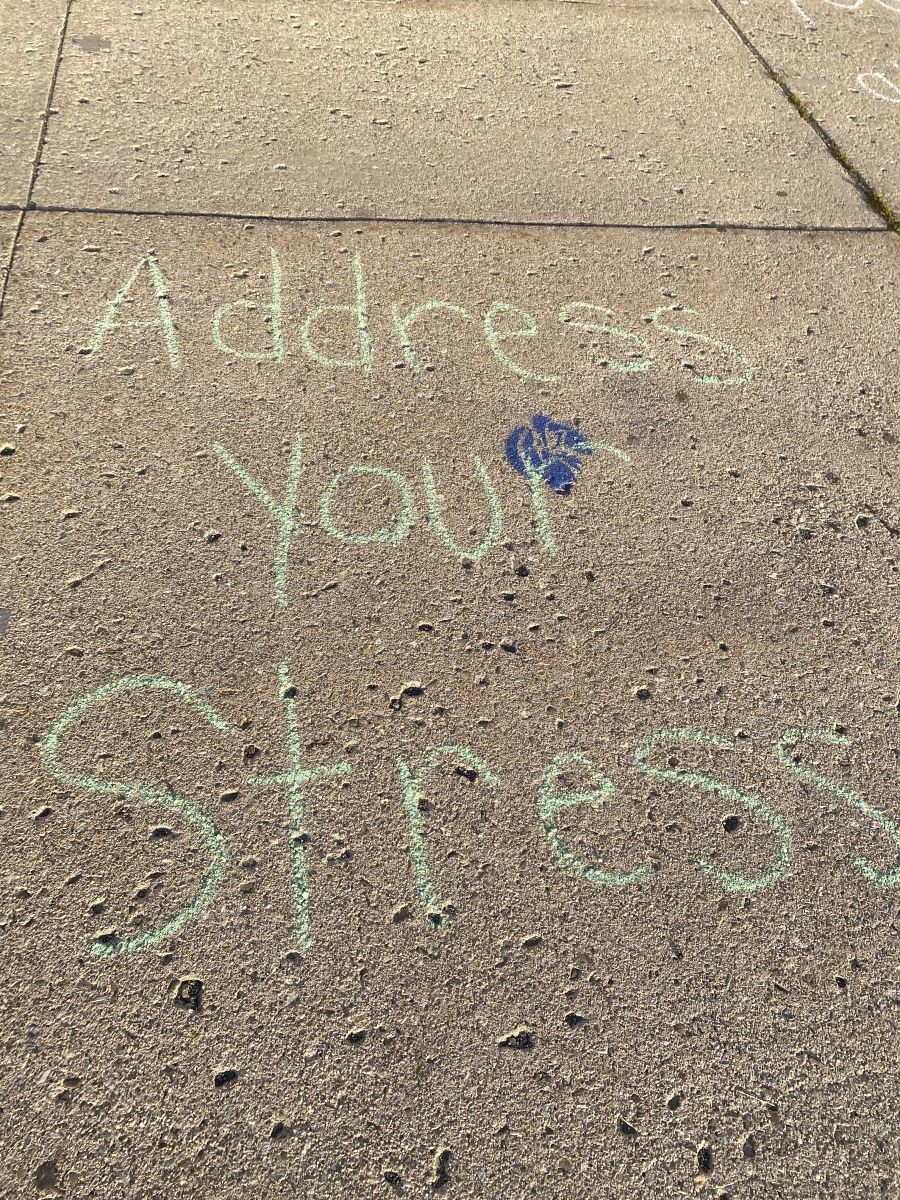 Sidewalk chalk with positive messages about mental health.