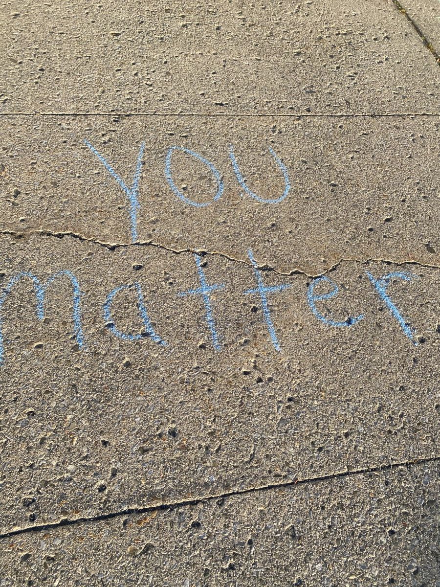 Sidewalk chalk with positive messages about mental health.