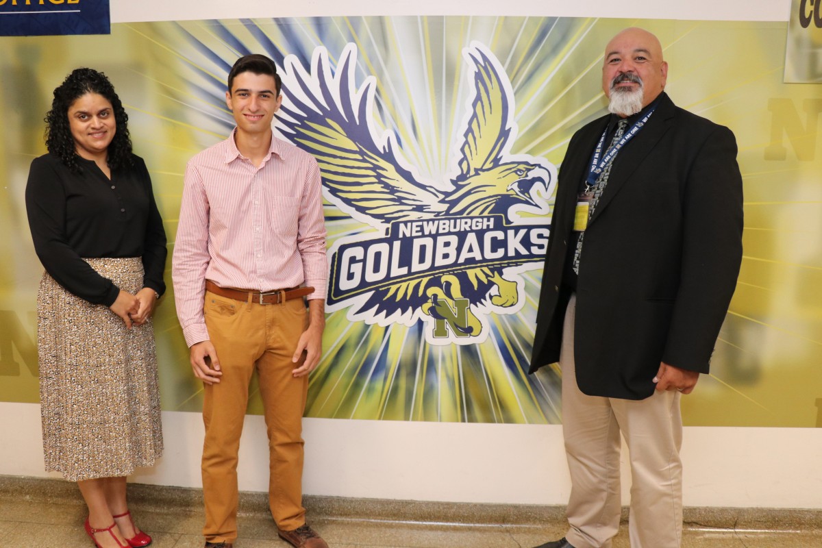 George Eliadis (center) is photographed with guidance counselor Ms. Juana Rivera (left) and principal Mr. Raul Rodriguez (right).