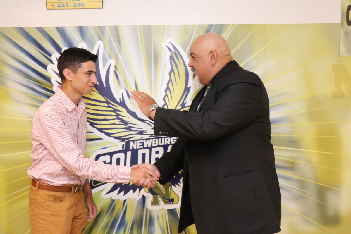 Student shakes hands with principal.