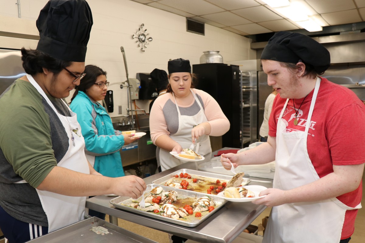 Students serving the meal.