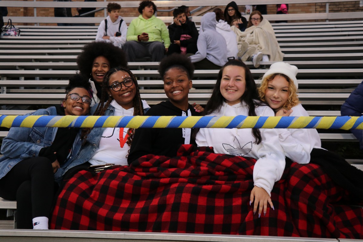 Fans arrive early to get a good seat. Seniors pose for a photo.