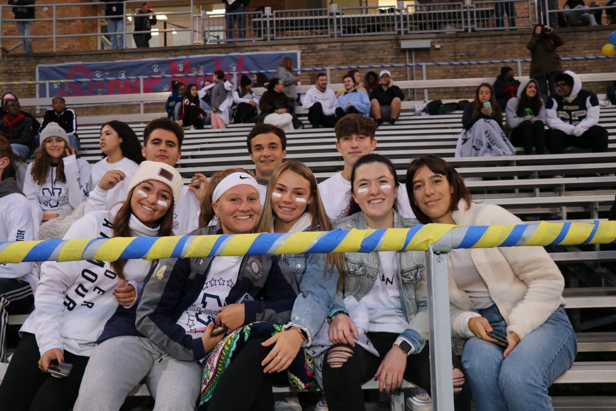 Fans arrive early to get a good seat. Seniors pose for a photo.