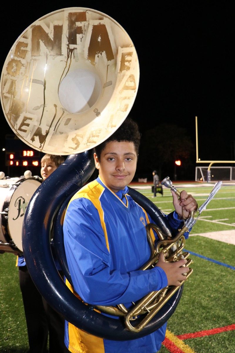 Member of the band shows off their decorated instrument.