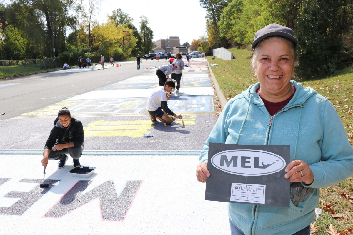 Parent holds up design for parking spot.