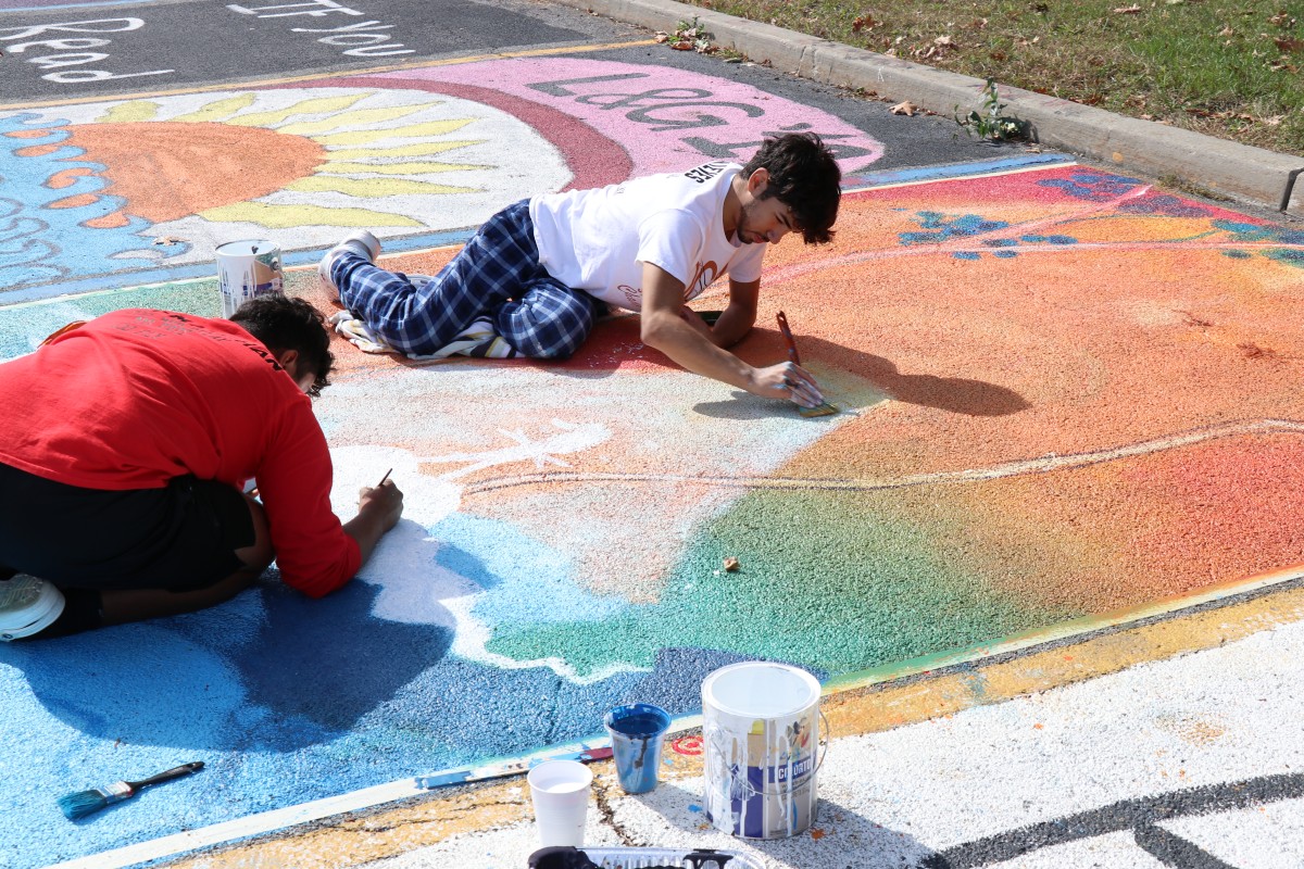 Student painting parking spot.