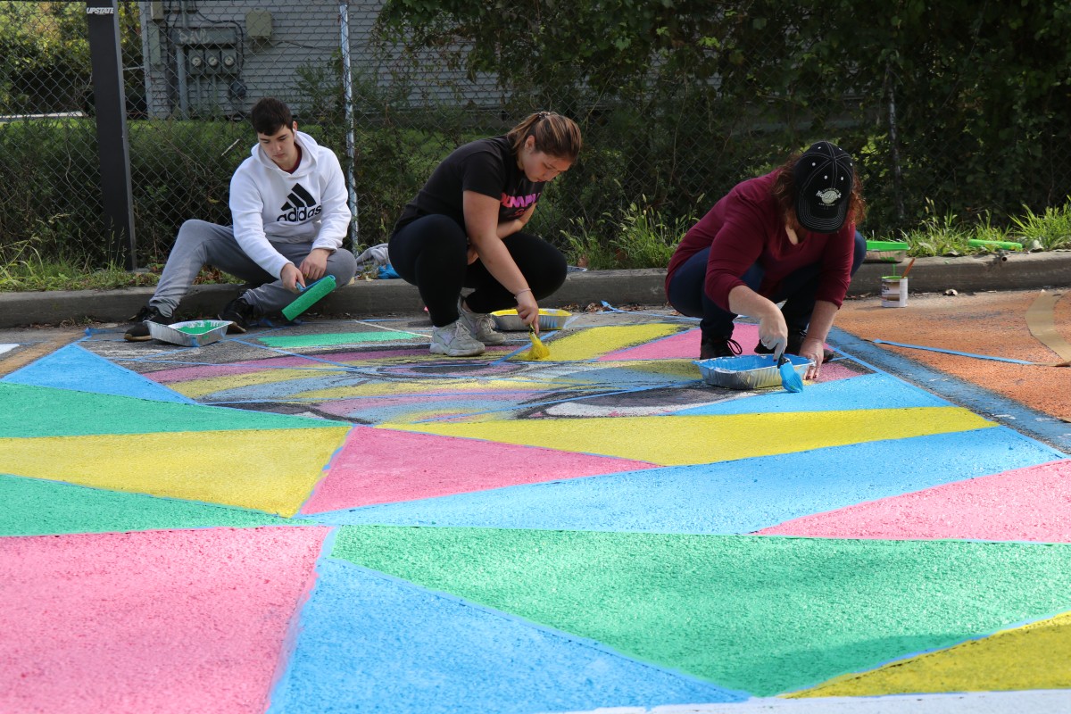 Students painting parking spot.