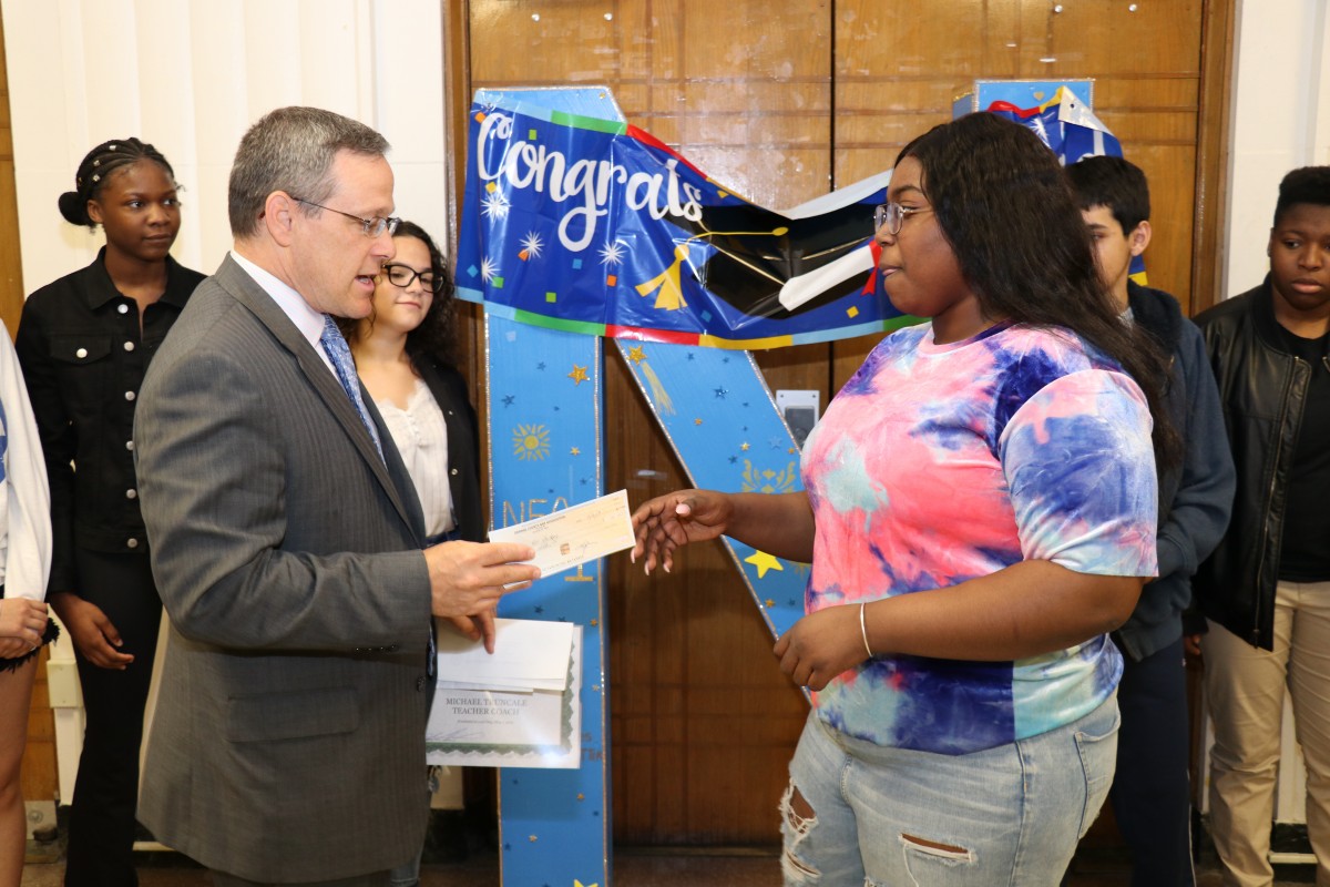 Student accepts award.