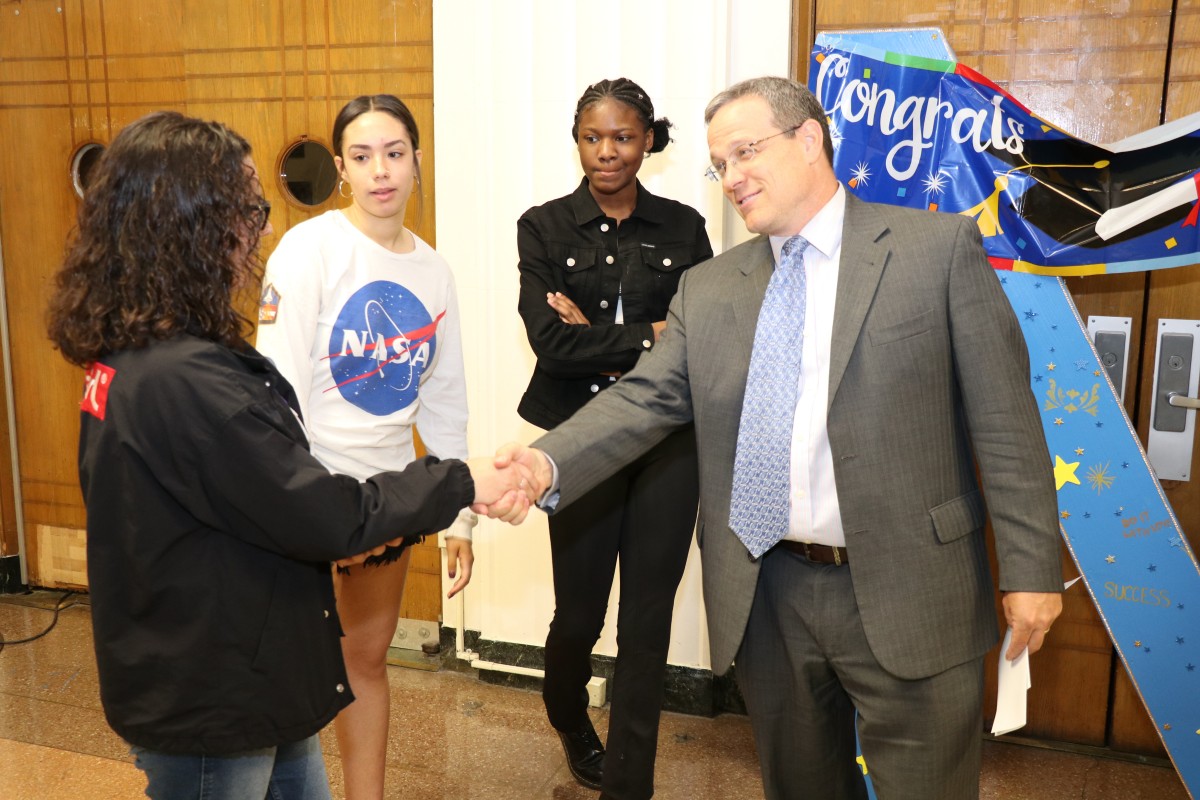 Judge congratulating members of the team.