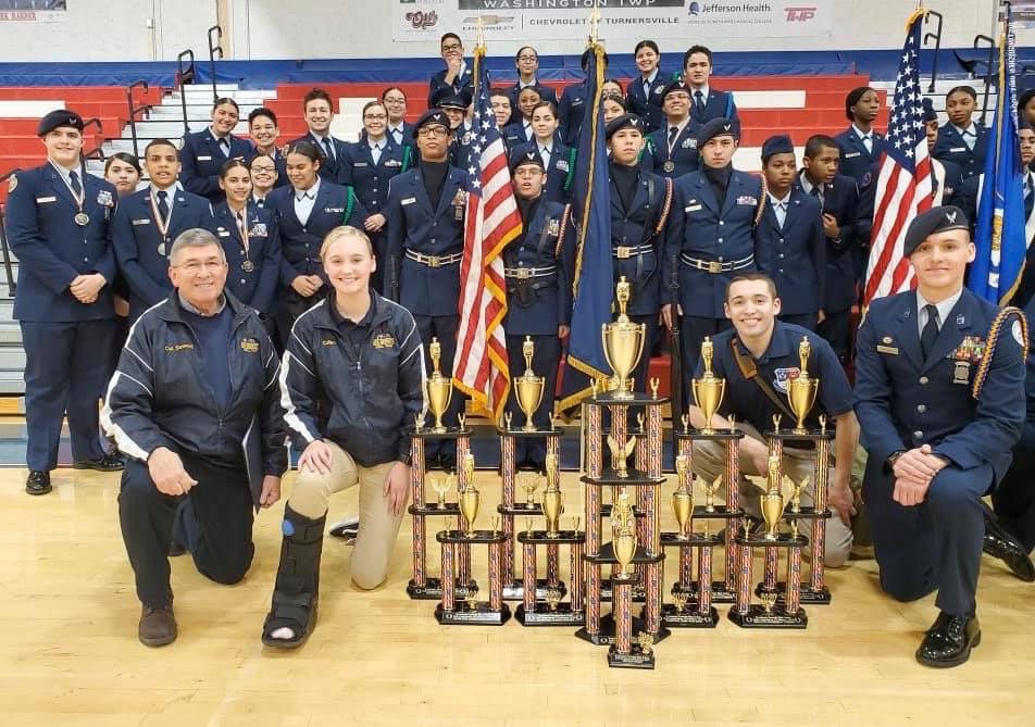 Members of the team stand with their trophy.