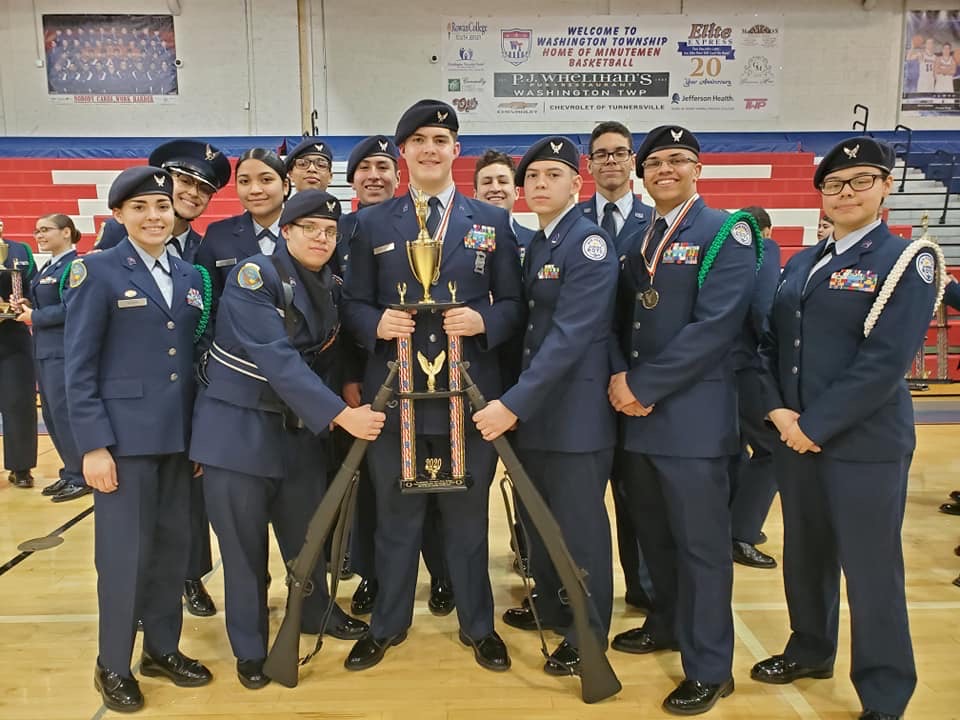 Members of the team stand with their trophy.