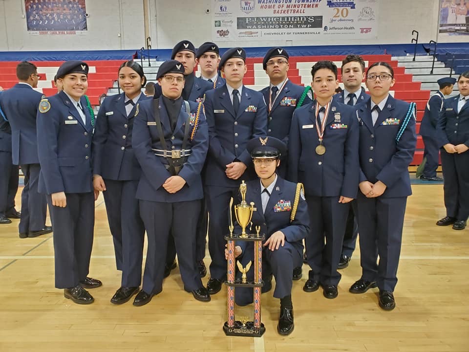 Members of the team stand with their trophy.