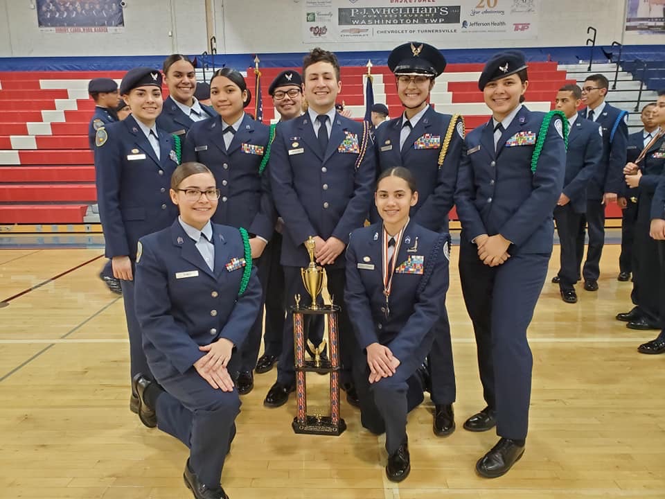 Members of the team stand with their trophy.