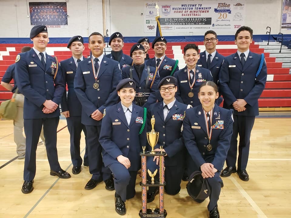 Members of the team stand with their trophy.