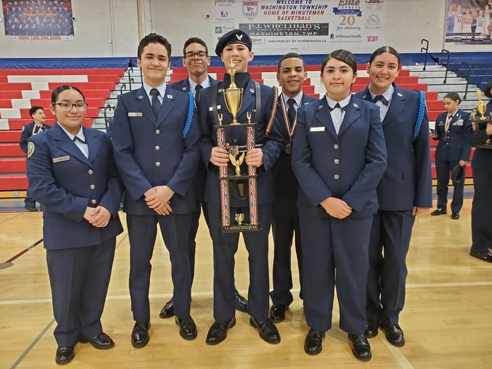 Members of the team stand with their trophy.