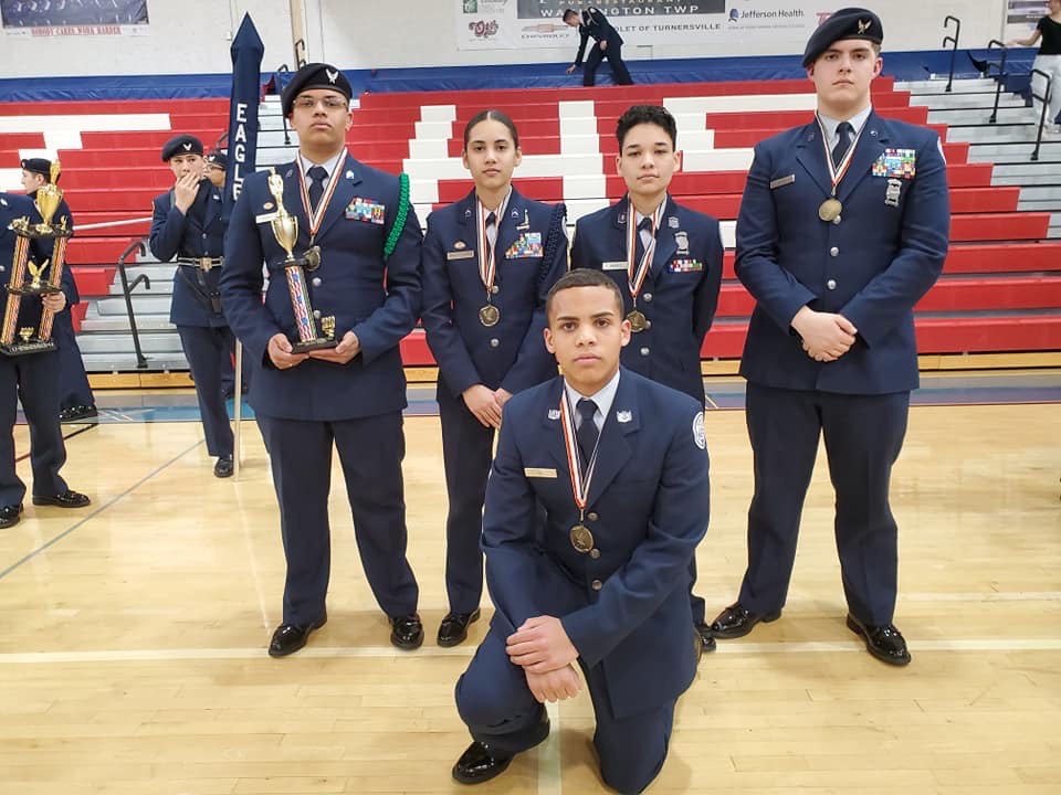 Members of the team stand with their trophy.