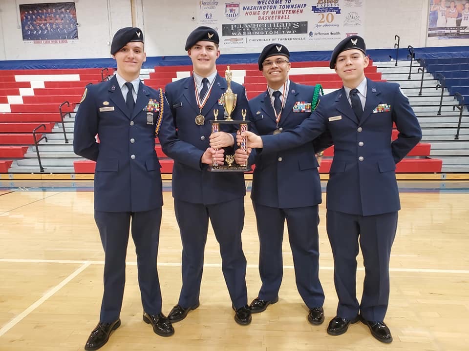 Members of the team stand with their trophy.