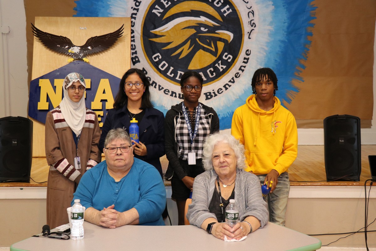 Students stand with board members.