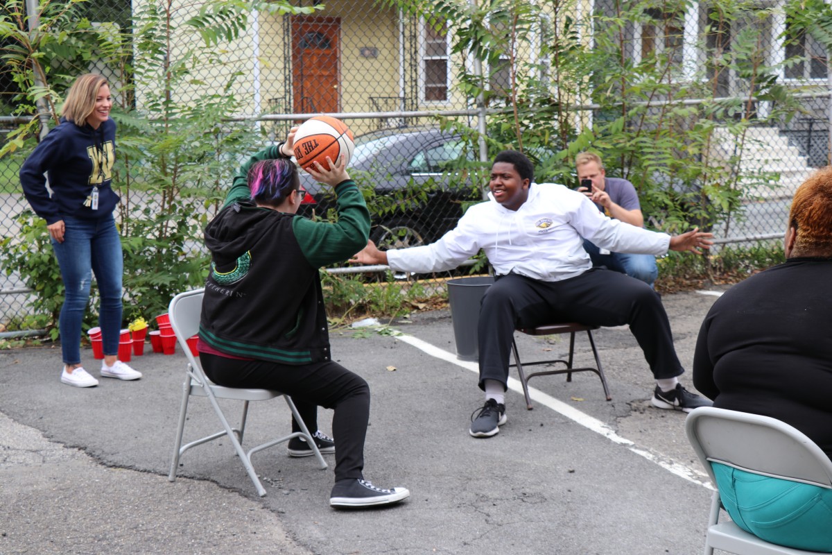 Students play seated basketball game.
