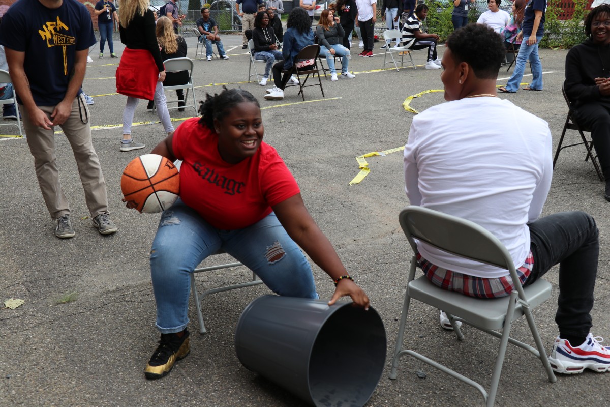 Students play seated basketball game.