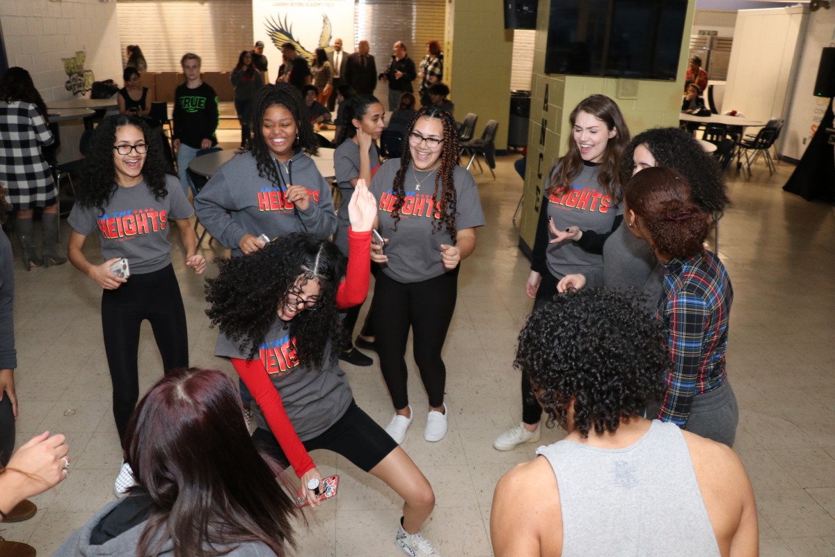 Students dancing in a group.