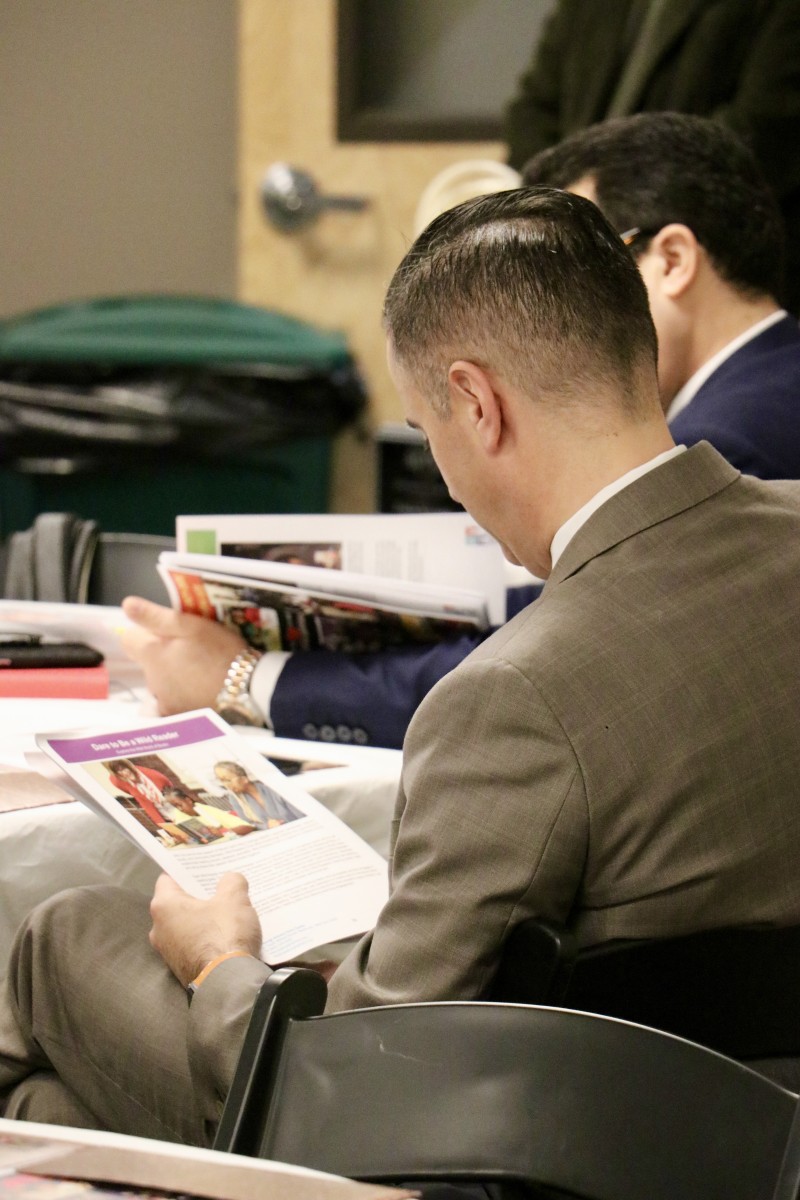 Superintendent looking at brochure