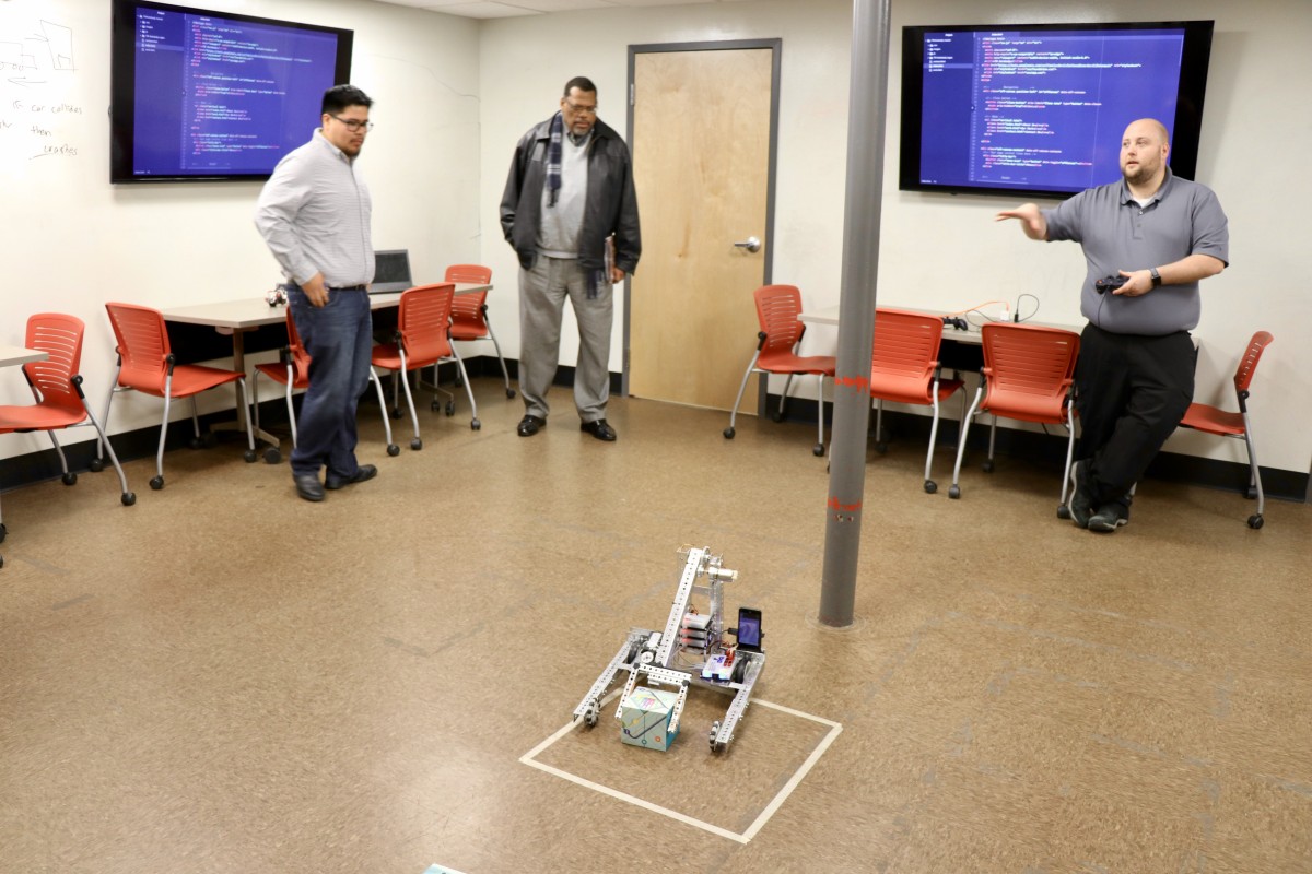 Mr. Svarczkopf shows off robot made by students