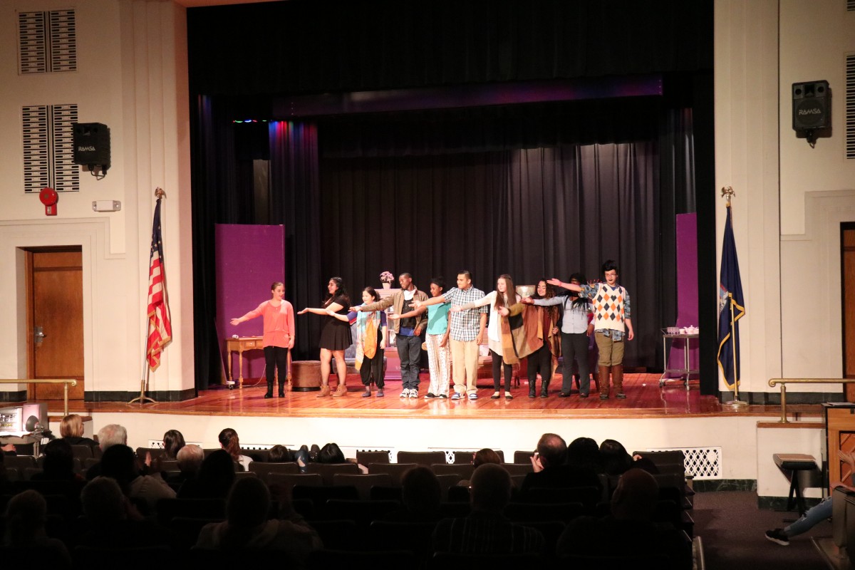 Performers acknowledge stage hands after a performance