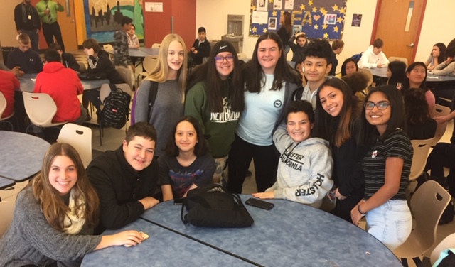 Scholars pose in a group at the event.