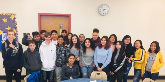 Scholars pose in a group at the event.