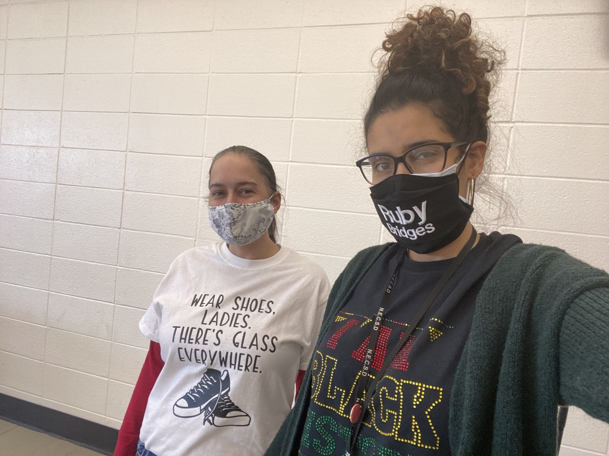 Faculty staff pose in t-shirts and masks that celebrate Black History Month.