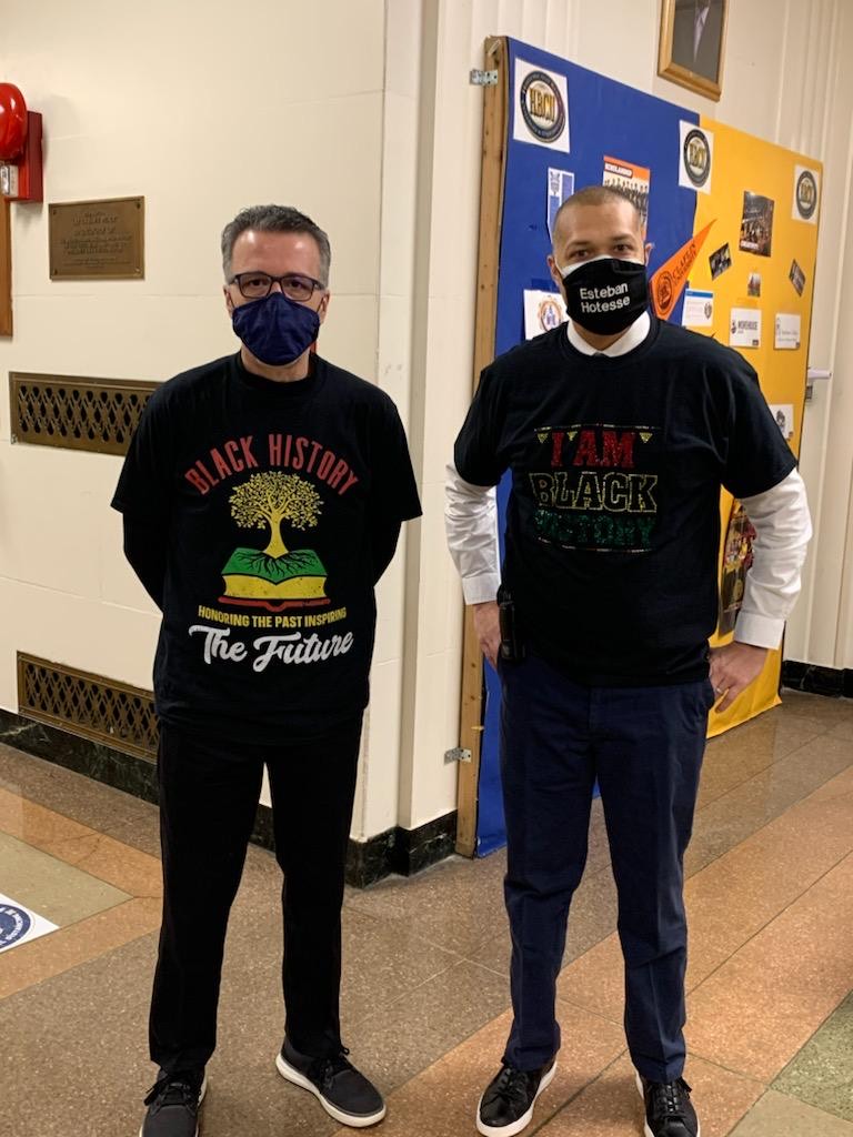 Faculty staff pose in t-shirts and masks that celebrate Black History Month.