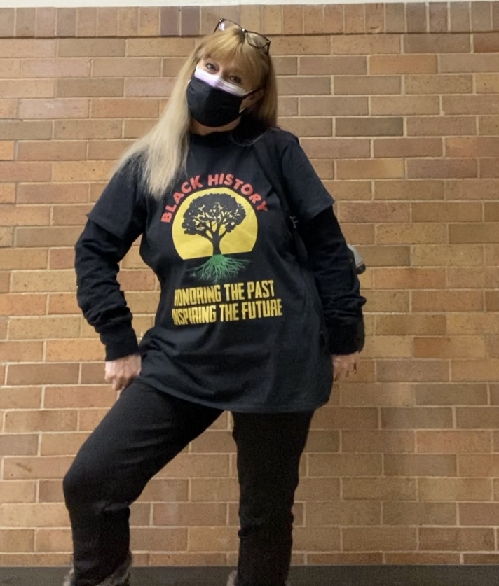 Faculty staff pose in t-shirts and masks that celebrate Black History Month.