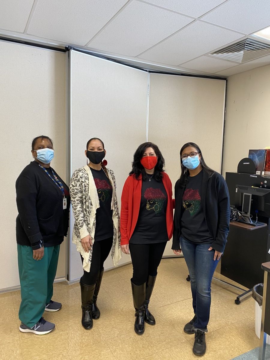 Faculty staff pose in t-shirts and masks that celebrate Black History Month.