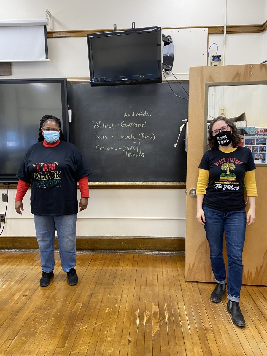 Faculty staff pose in t-shirts and masks that celebrate Black History Month.