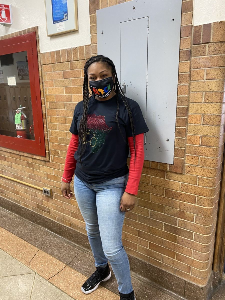 Faculty staff pose in t-shirts and masks that celebrate Black History Month.