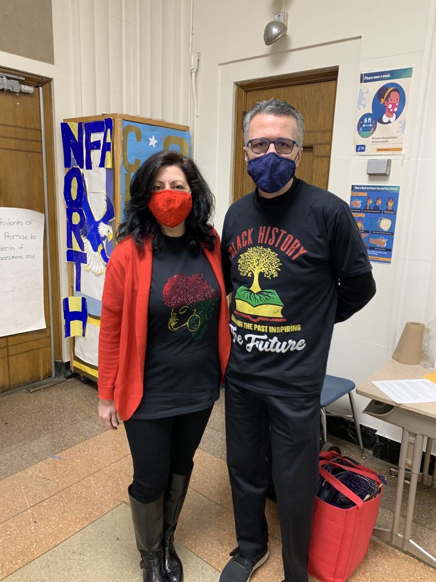 Faculty staff pose in t-shirts and masks that celebrate Black History Month.