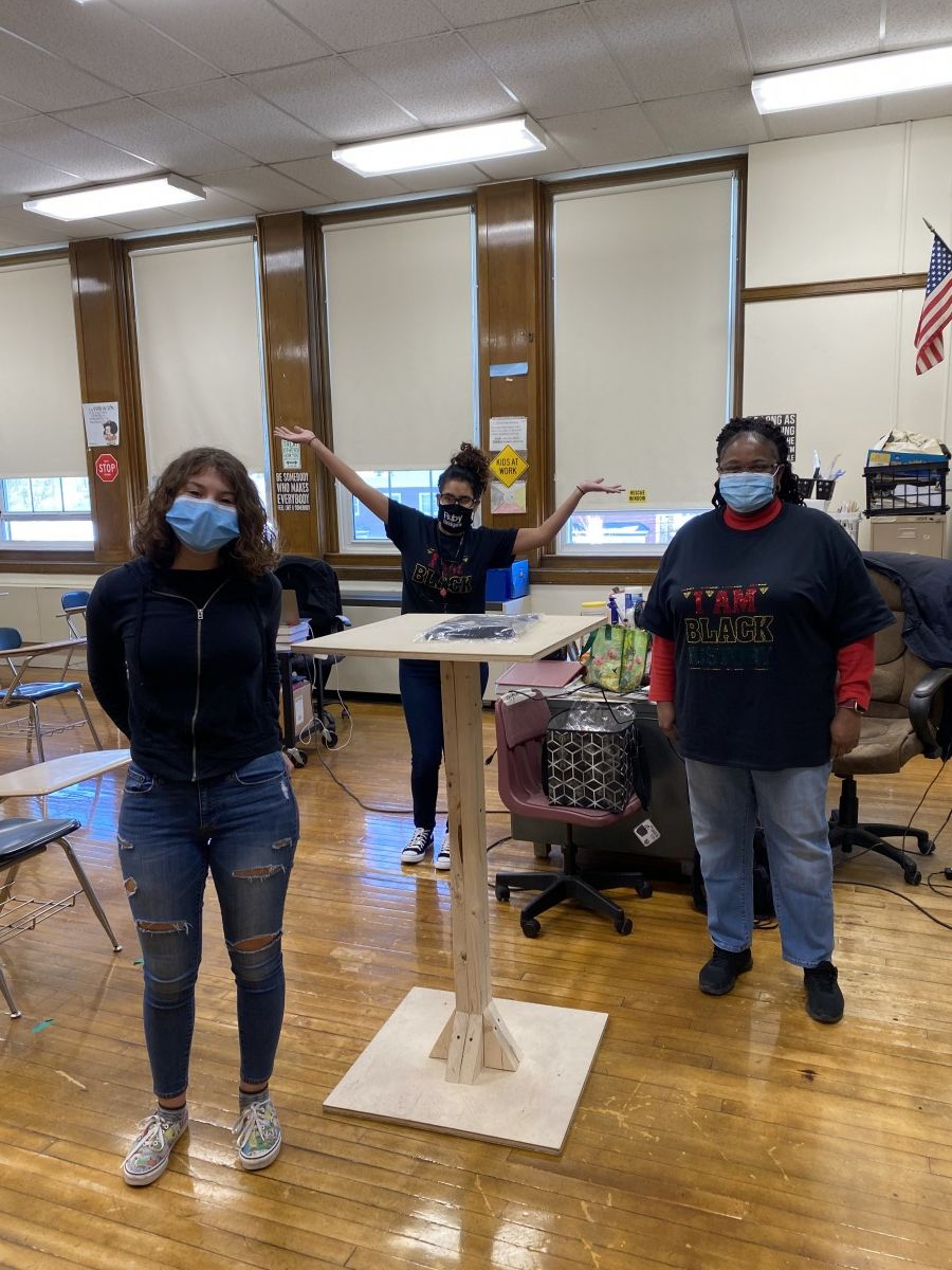 Faculty staff pose in t-shirts and masks that celebrate Black History Month.