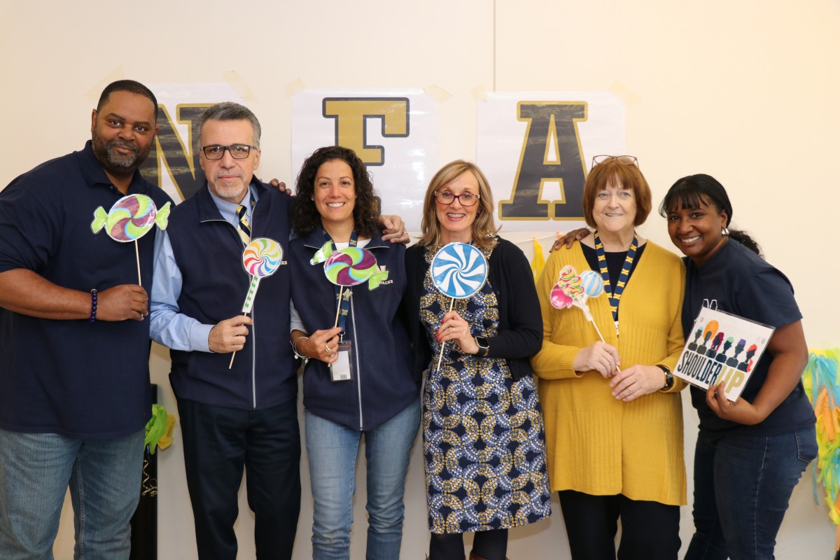 Faculty and staff pose for a photo.