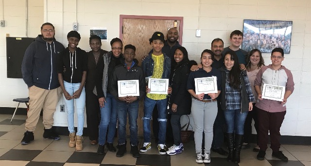 Students pose with award