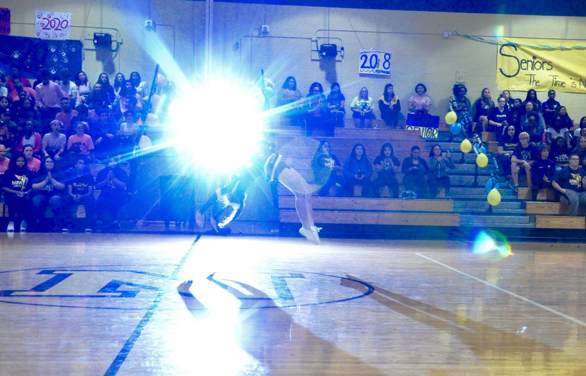 A cheerleader tumbles at the Pep Rally