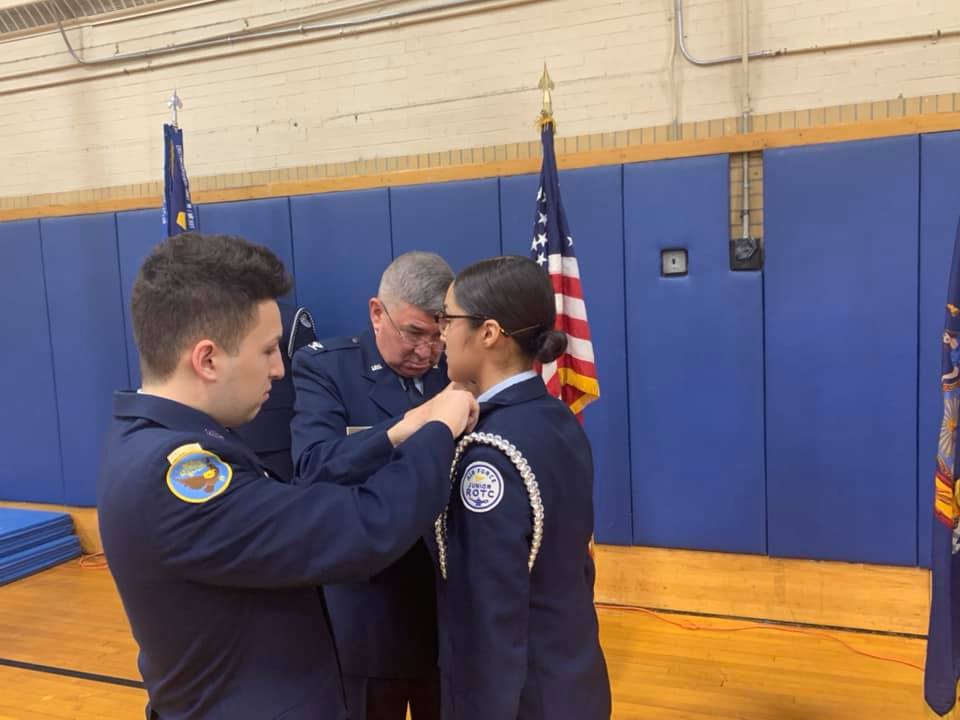 Student receiving updated pins.