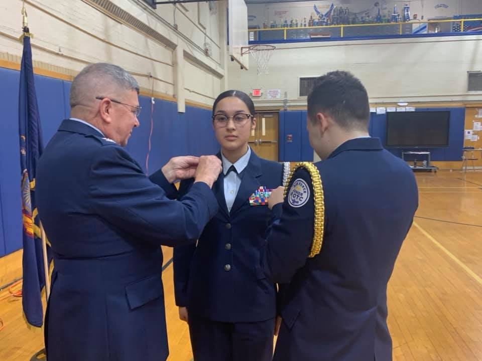 Student receiving updated pins.