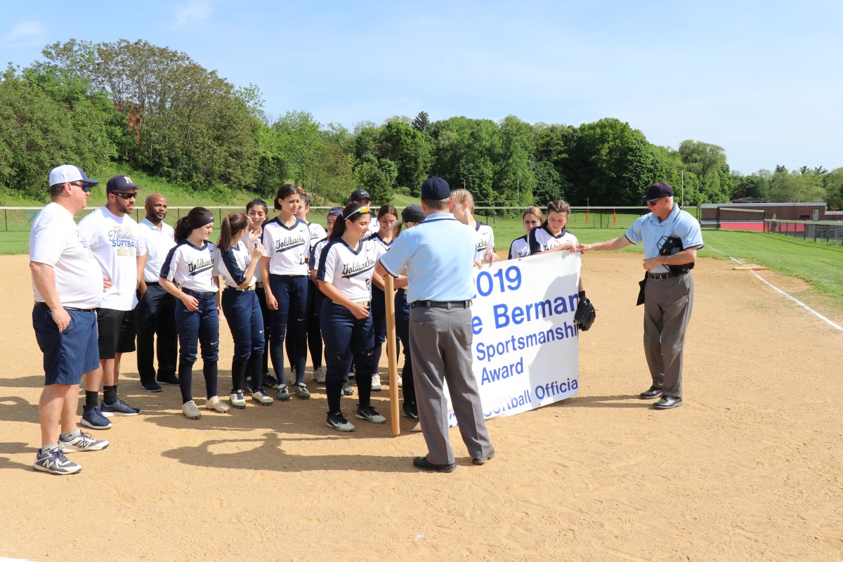 Team being presented award banner.