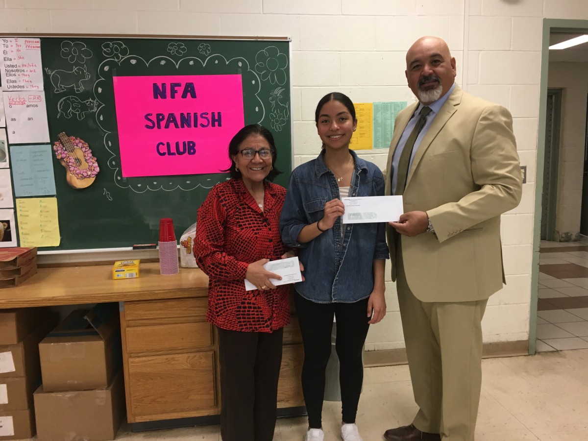 Award recipient from Spanish Club stand with club advisor Mrs. Kennedy and co-principal of NFA Main, Mr. Raul Rodriguez.