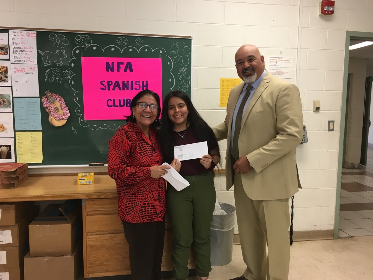 Award recipient from Spanish Club stand with club advisor Mrs. Kennedy and co-principal of NFA Main, Mr. Raul Rodriguez.